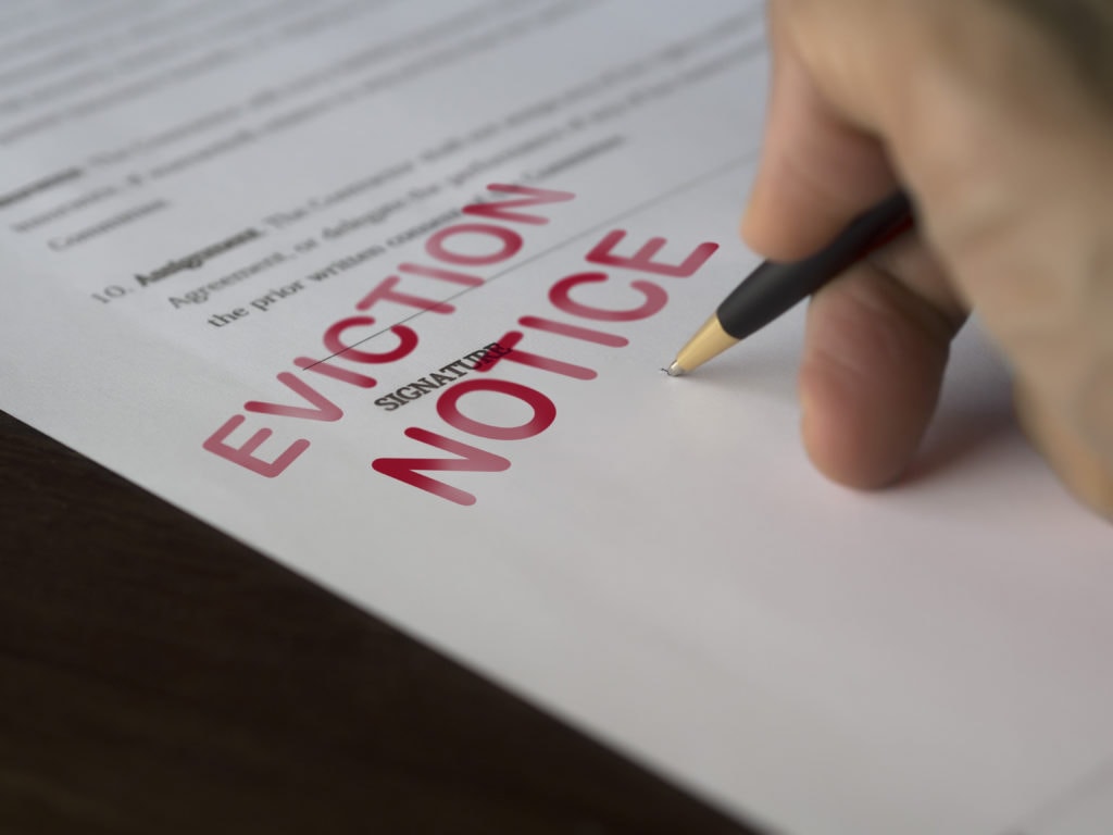 Man signing eviction papers